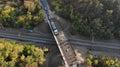 Aerial. Truck driving through the bridge above the railroad