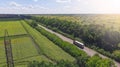 Aerial. Truck driving by the roadway between agricultural fields