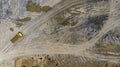 Aerial. Truck loaded with construction waste moves on a dirt road. Preparing land for large construction. Top view from drone