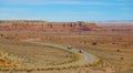 AERIAL: Two trucks drive along the empty highway winding through the Utah desert Royalty Free Stock Photo
