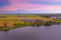 Aerial from a typical dutch landscape with windmills, water en far views