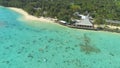 AERIAL: Unrecognizable people on vacation having fun in the turquoise water. Royalty Free Stock Photo