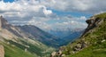 AERIAL: Unrecognizable woman standing on a hill and observing the vast valley.