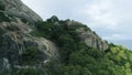 AERIAL. Unveiling drone shot of rock mountain in the sea of Hua Hin, Thailand. Place for title / text.