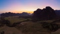 Aerial: Vang Vieng backpacker travel destination in Laos, Asia. Sunset over scenic cliffs and rock pinnacles, rice paddies valley