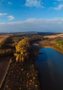 Aerial vertcal view of lake at sunrise in autumn. Meadows, trees at dawn. Colorful aerial landscape of river coast at sunset in Royalty Free Stock Photo