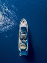 Aerial vertical shot of a yacht sailing on the sea Royalty Free Stock Photo