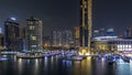 Aerial vew of Dubai Marina with shoping mall, restaurants, towers and yachts night timelapse, United Arab Emirates.