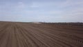 Aerial video of big tractor with cultivator ploughs field