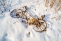 aerial view of abandoned bicycle half-buried in snow