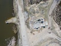 Aerial view of the abandoned and destroyed building with a large number broken bricks from the roofless walls with rubbish and Royalty Free Stock Photo