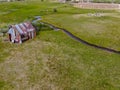 Aerial view of abandoned little small wooden house in the green valley of a mountain