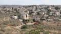 Aerial view of Aboud village in Palestine with a cloudy blue sky in the background