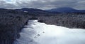 Flying over magical snow covered landscape at sunrise in New England