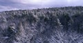 Flying over magical snow covered landscape at sunrise in New England