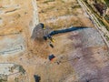 Aerial view from above of dumping site. Garbage trucks. Yellow tractor. Waste sorting. Landfill of big city Royalty Free Stock Photo
