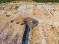 Aerial view from above of dumping site. Garbage trucks. Yellow tractor. Waste sorting. Landfill of big city Royalty Free Stock Photo