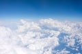 Aerial view from above at high altitude of dense puffy cumulus clouds flying in day Royalty Free Stock Photo