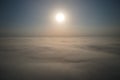 Aerial view from above at high altitude of dense puffy cumulus clouds flying in evening. Amazing sunset from airplane Royalty Free Stock Photo