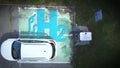 Aerial view above a Hydrogen car parking at a refill station, tanking with h2. Royalty Free Stock Photo