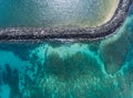 Aerial view above the Ocean and breakwater