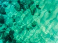 Aerial view above the Ocean, rocks and beach