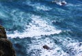 Aerial view from above of ocean, rocks and water waves in Pacific ocean. Royalty Free Stock Photo
