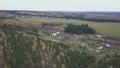 Aerial view from above over small village. Clip. Ecological place for agriculture activity and for the living located