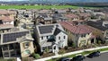 Aerial view above residential neighborhood houses with clean solar renewable energy panels on rooftops