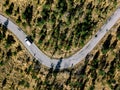 Aerial view from above of a rural landscape with a curvy road and white car in Italy Royalty Free Stock Photo