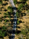 Aerial view from above of a rural landscape with a curvy road and white car in Italy Royalty Free Stock Photo