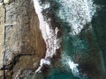 Aerial view from above on sea vawes , waves and foam crashing on the beach forming beautiful textures, patterns