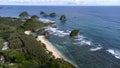 Aerial view from above of the shoreline, waves and small islands on Watu Leter Beach