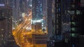 Aerial view from above to a busy road junction in Dubai all night timelapse. Royalty Free Stock Photo