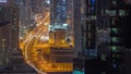 Aerial view from above to a busy road junction in Dubai all night timelapse. Royalty Free Stock Photo