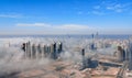 Aerial view of Abu Dhabi city skyline, famous towers and skyscrapers surrounded by fog clouds in the morning Royalty Free Stock Photo