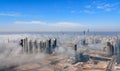 Aerial view of Abu Dhabi city skyline, famous towers and skyscrapers surrounded by fog clouds in the morning