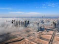 Aerial view of Abu Dhabi city skyline, famous towers and skyscrapers surrounded by fog clouds in the morning Royalty Free Stock Photo