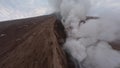 Aerial view active erupting volcano summit hot lava smoke stream extreme disaster