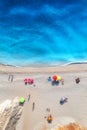 Aerial view of adriatic sea, waves, sandy beach and umbrellas