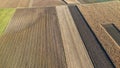 Aerial view of agricultural fields displaying distinct patterns and colors, illustrating crop rotation and farming techn Royalty Free Stock Photo