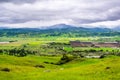 Aerial view of agricultural fields and green hills on cloudy spring day; Santa Cruz mountains in the background, south San Royalty Free Stock Photo