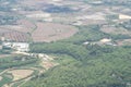 Aerial view of agricultural fields, river, mountains, and land have seen through the airplane window Royalty Free Stock Photo