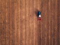 Aerial view of agricultural tractor doing stubble tillage