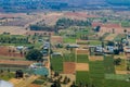 Aerial view of agriculture lands of Karnataka near Bangalore. Green and brown patches are seen from drone shot with roads passing Royalty Free Stock Photo