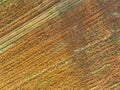 Aerial view of agriculture plowed field. Minimal tillage for healthier soils. Fertile soil in organic agricultural farm. Soil