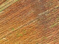 Aerial view of agriculture plowed field. Minimal tillage for healthier soils. Fertile soil in organic agricultural farm. Soil