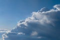 Aerial view from airplane of rain clouds and blue sky