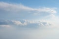 Aerial view from airplane of rain clouds and blue sky