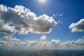 Aerial view from airplane window at high altitude of earth covered with white puffy cumulus clouds Royalty Free Stock Photo